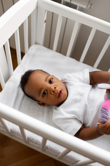 child sleeping in cot